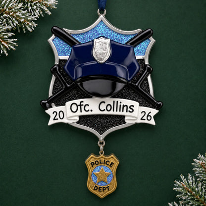 Personalized police officer christmas ornament on a dark green pine background