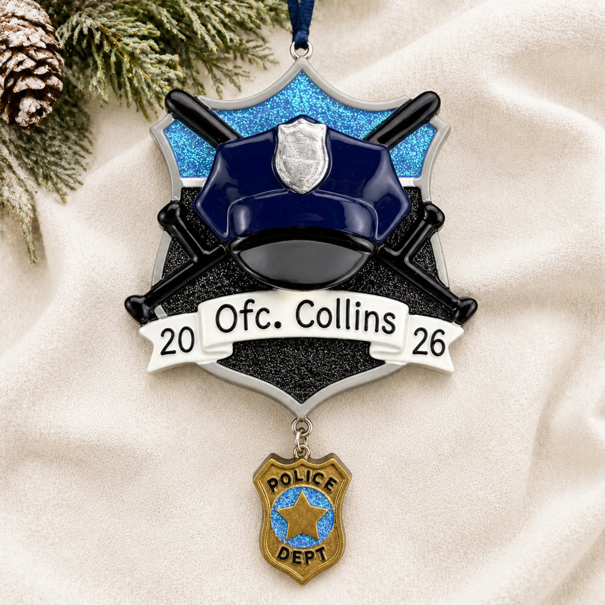 Personalized police officer christmas ornament laid on a soft white knit blanket