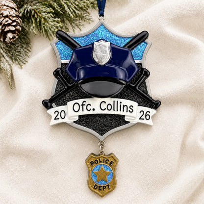 Personalized police officer christmas ornament laid on a soft white knit blanket