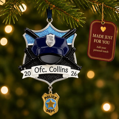 Police officer christmas ornament hanging on a lit Christmas tree with a Made Just For You gift tag