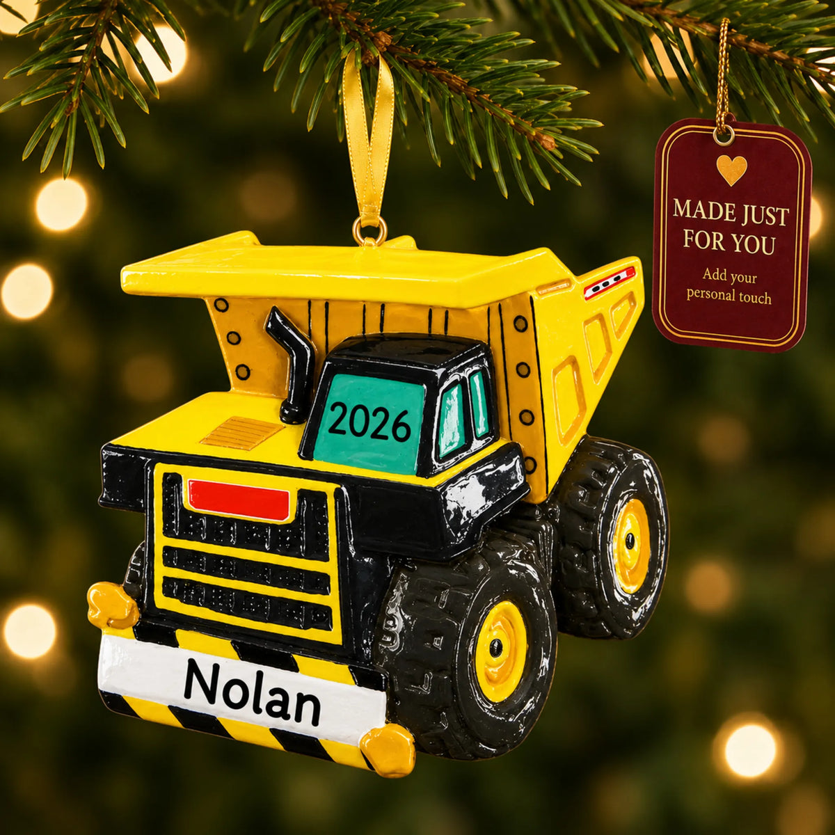 Dump truck xl christmas ornament hanging on a lit Christmas tree with a Made Just For You gift tag