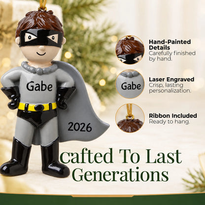 Hand-painted details and laser engraved personalization on the caped super hero christmas ornament, ribbon included
