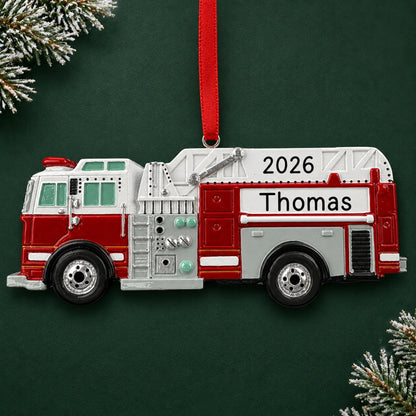 Personalized firetruck christmas ornament on a dark green pine background