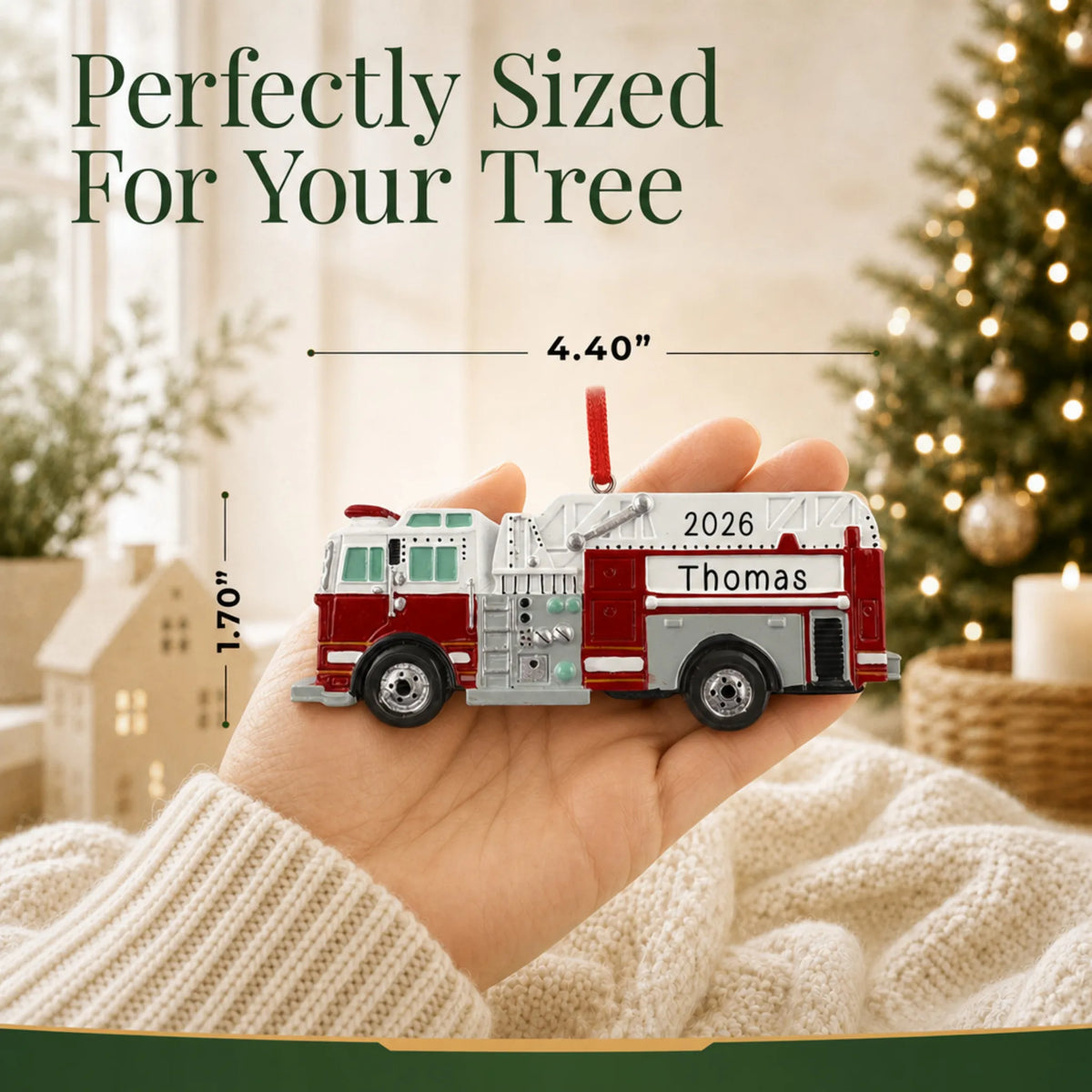 Size guide: the personalized firetruck christmas ornament is 4.40 in wide by 1.70 in tall, shown in hand