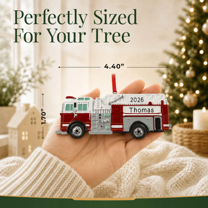 Size guide: the personalized firetruck christmas ornament is 4.40 in wide by 1.70 in tall, shown in hand