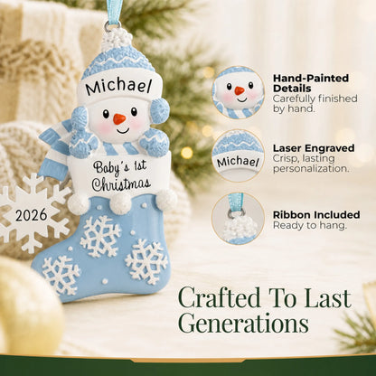 Hand-painted details and laser engraved personalization on the blue snowman baby's 1st christmas ornament, ribbon included