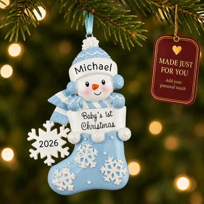 Blue snowman baby's 1st christmas ornament hanging on a lit Christmas tree with a Made Just For You gift tag