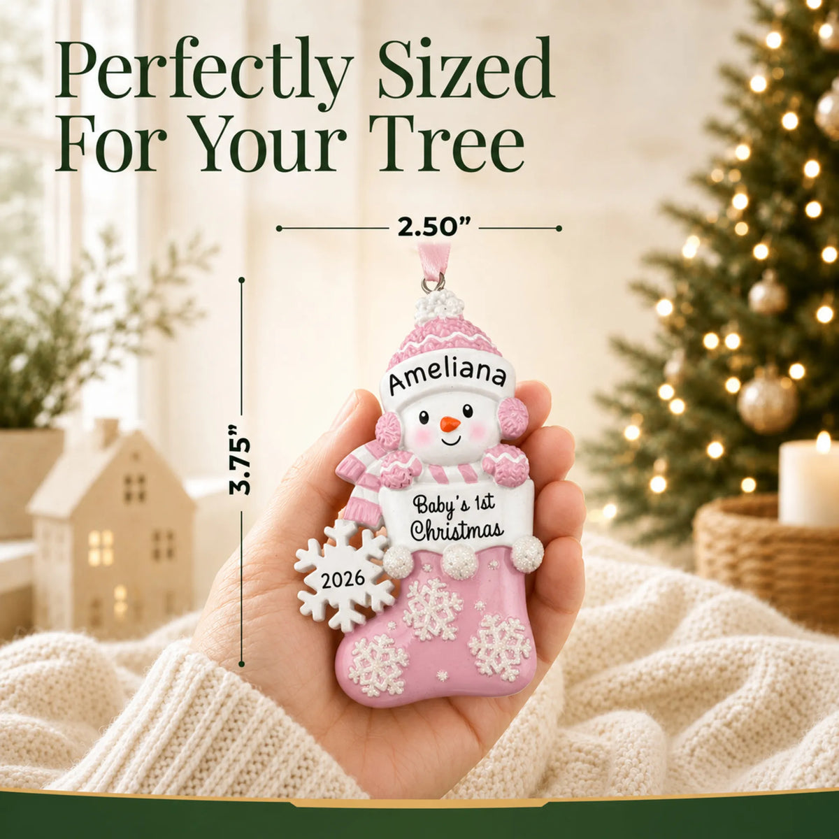 Size guide: the personalized pink snowman baby's 1st christmas ornament is 2.50 in wide by 3.75 in tall, shown in hand