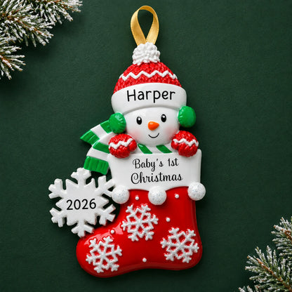 Personalized red snowman baby's 1st christmas ornament on a dark green pine background
