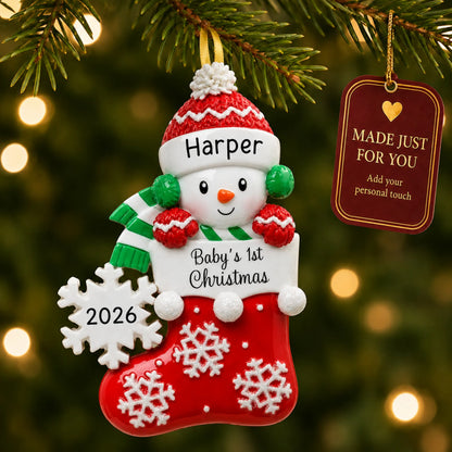 Red snowman baby's 1st christmas ornament hanging on a lit Christmas tree with a Made Just For You gift tag