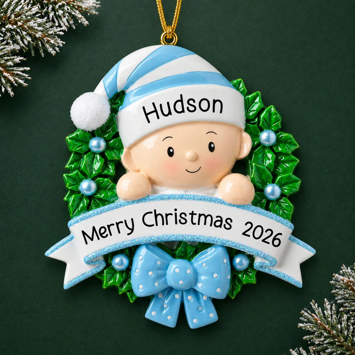 Personalized blue baby boy wreath christmas ornament on a dark green pine background