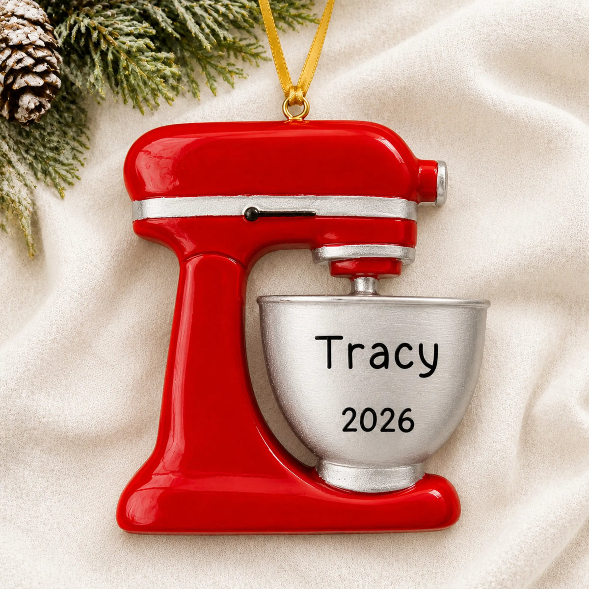 Personalized Food Mixer christmas ornament laid on a soft white knit blanket