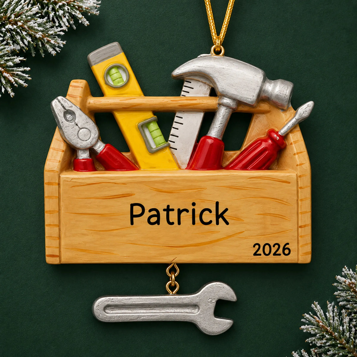 Personalized handyman tool box christmas ornament on a dark green pine background