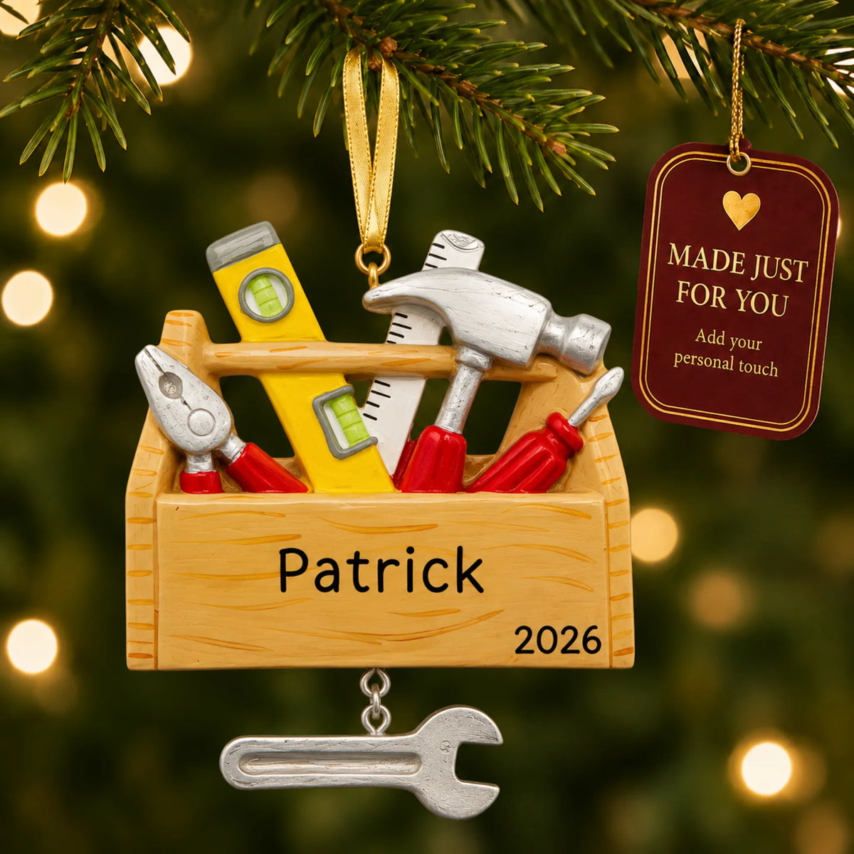 Handyman tool box christmas ornament hanging on a lit Christmas tree with a Made Just For You gift tag