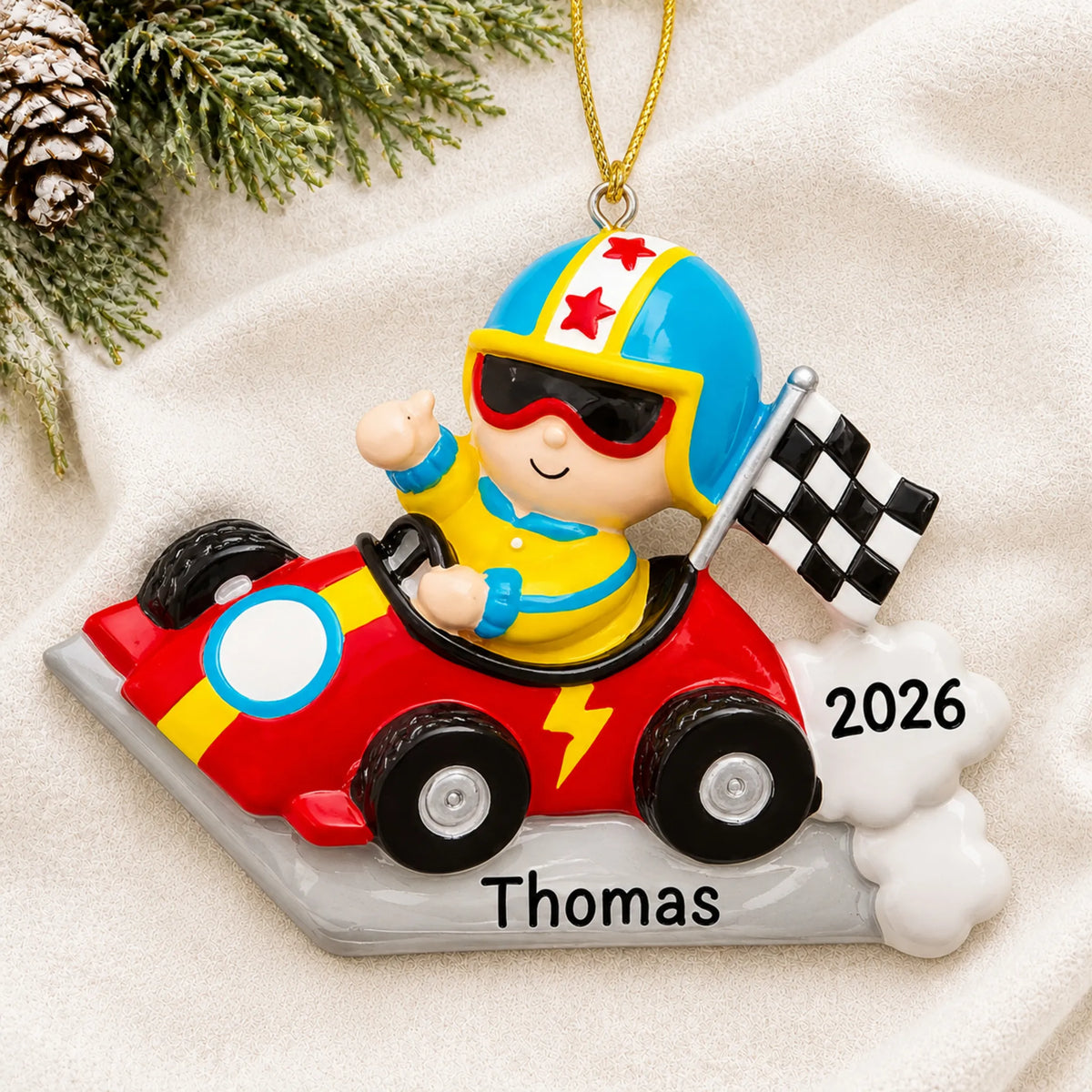 Personalized go-kart race car christmas ornament laid on a soft white knit blanket