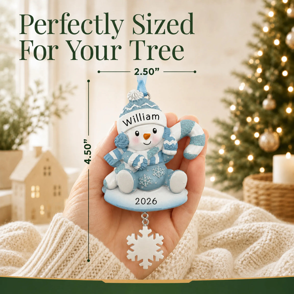 Size guide: the personalized baby boy snowman christmas ornament shown in hand next to a Christmas tree
