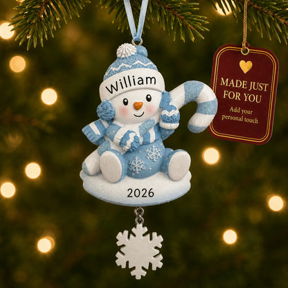 Baby boy snowman christmas ornament hanging on a lit Christmas tree with a Made Just For You gift tag