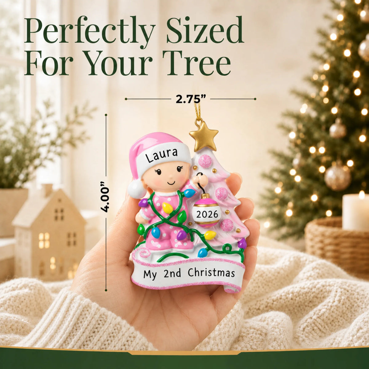 Size guide: the personalized pink baby's 2nd christmas ornament is 2.75 in wide by 4.00 in tall, shown in hand