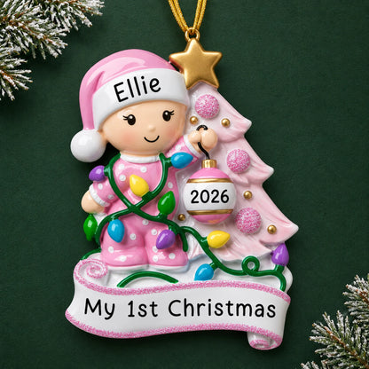 Personalized pink baby's 1st christmas tree ornament on a dark green pine background