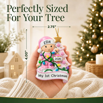 Size guide: the personalized pink baby's 1st christmas tree ornament is 2.75 in wide by 4.00 in tall, shown in hand