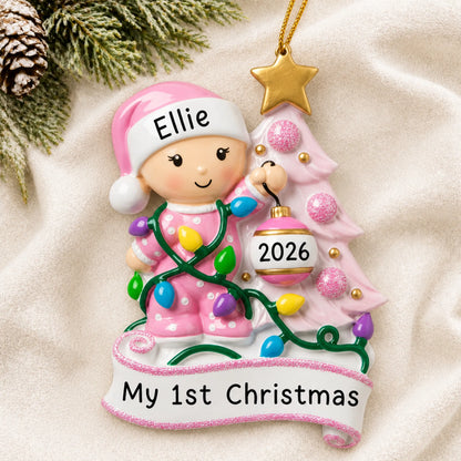 Personalized pink baby's 1st christmas tree ornament laid on a soft white knit blanket