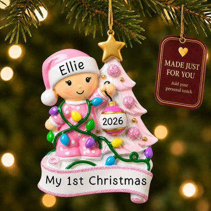 Pink baby's 1st christmas tree ornament hanging on a lit Christmas tree with a Made Just For You gift tag