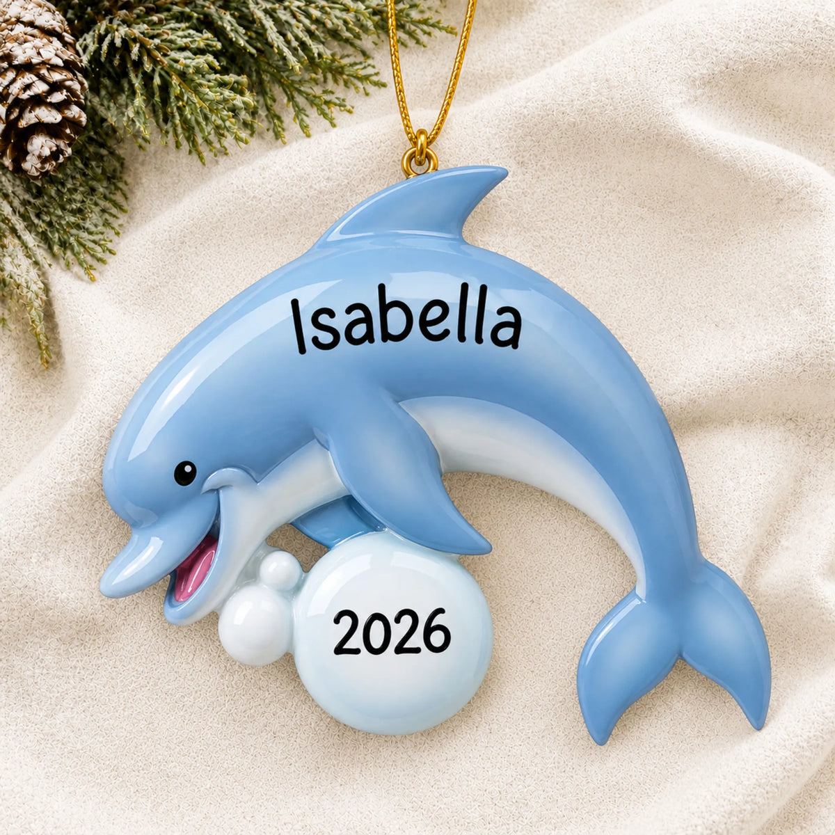 Personalized dolphin fun christmas ornament laid on a soft white knit blanket