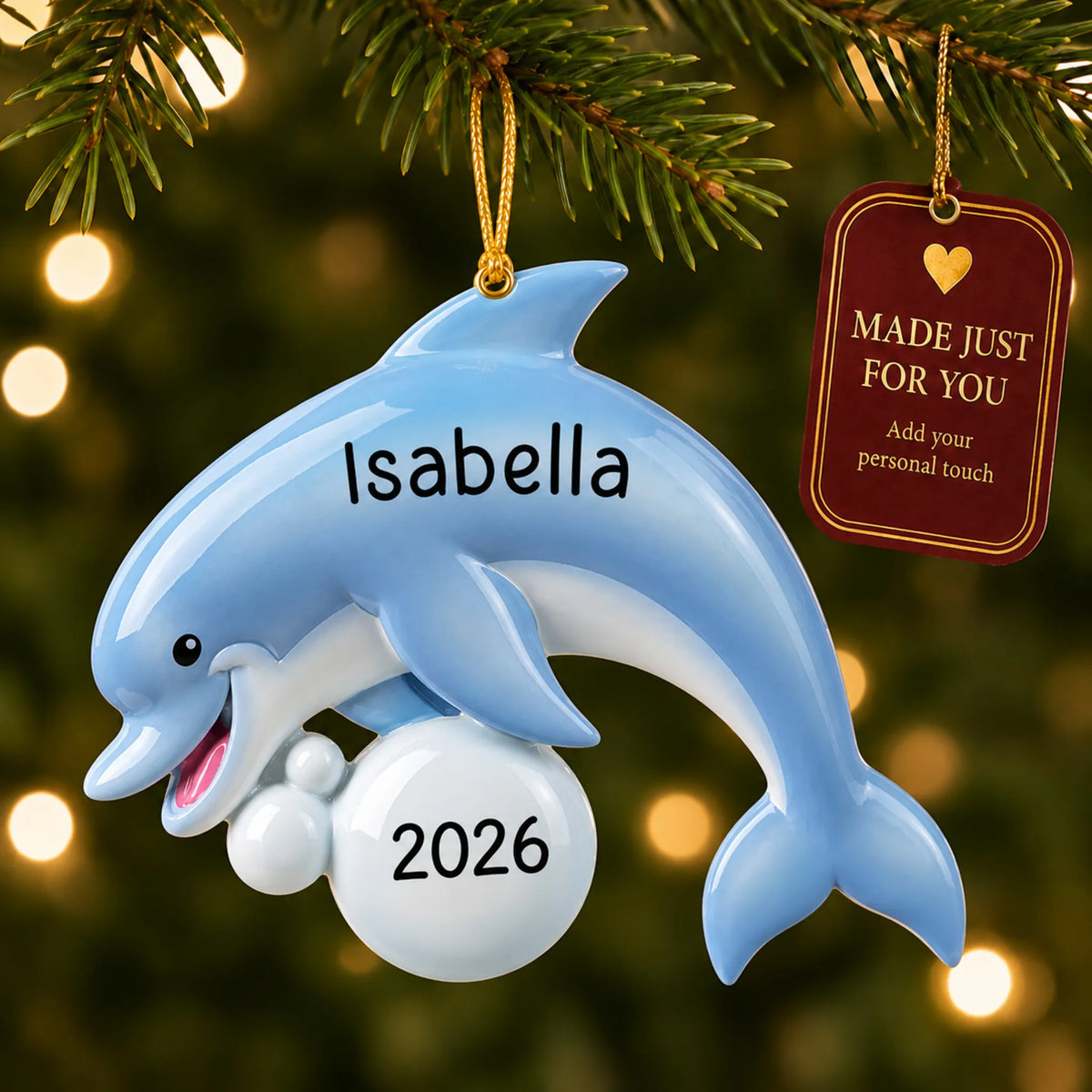 Dolphin fun christmas ornament hanging on a lit Christmas tree with a Made Just For You gift tag