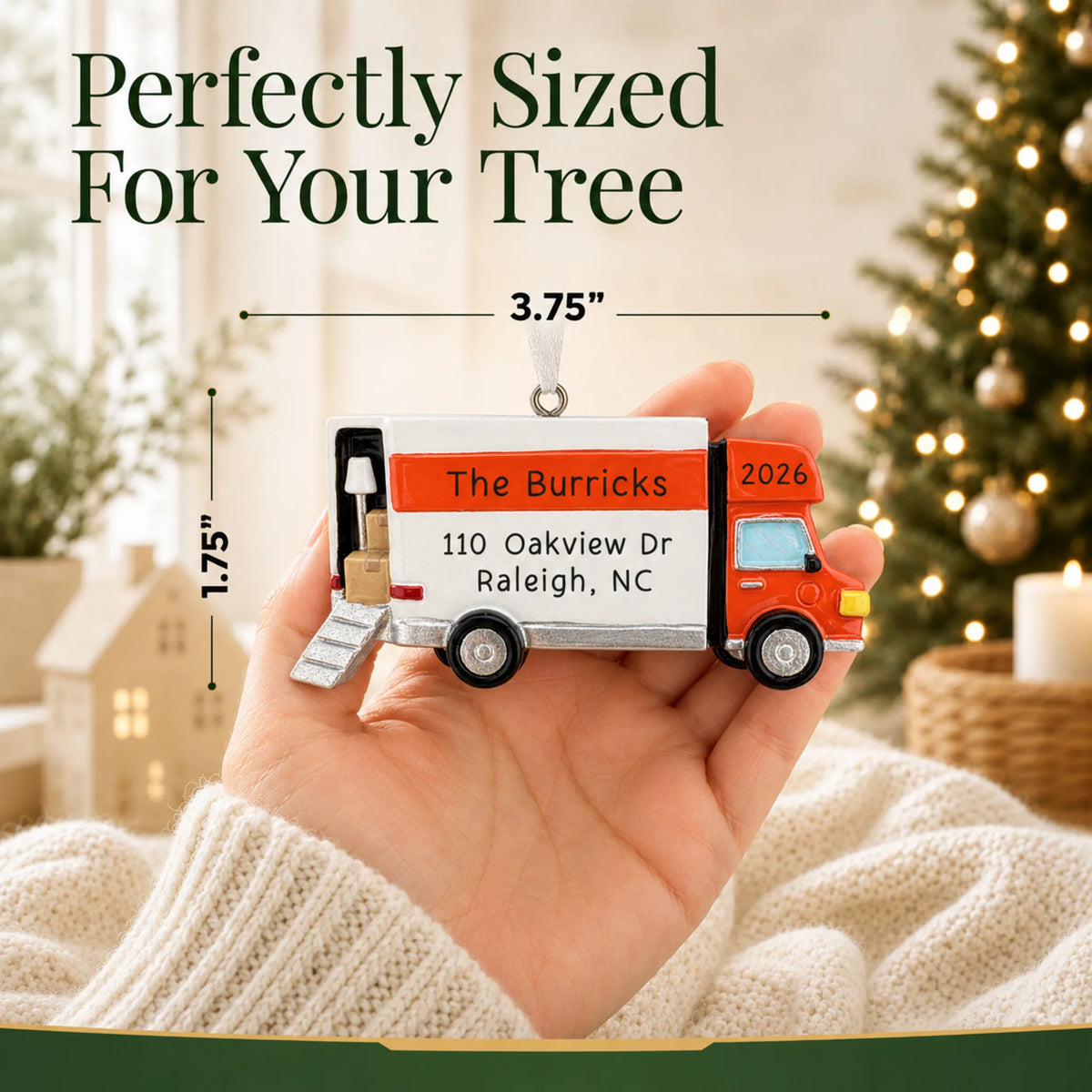 Size guide: the personalized Moving Truck christmas ornament is 3.75 in wide by 1.75 in tall, shown in hand