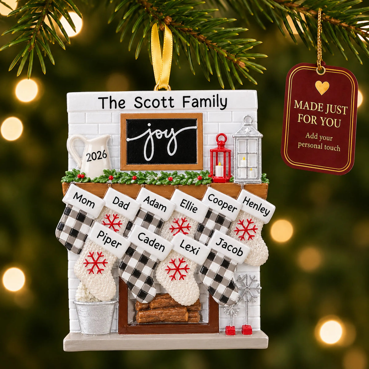 Fireplace stockings family of 10 christmas ornament hanging on a lit Christmas tree with a Made Just For You gift tag