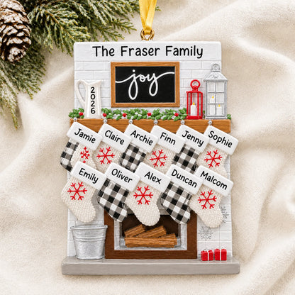 Personalized fireplace stockings family of 11 christmas ornament laid on a soft white knit blanket