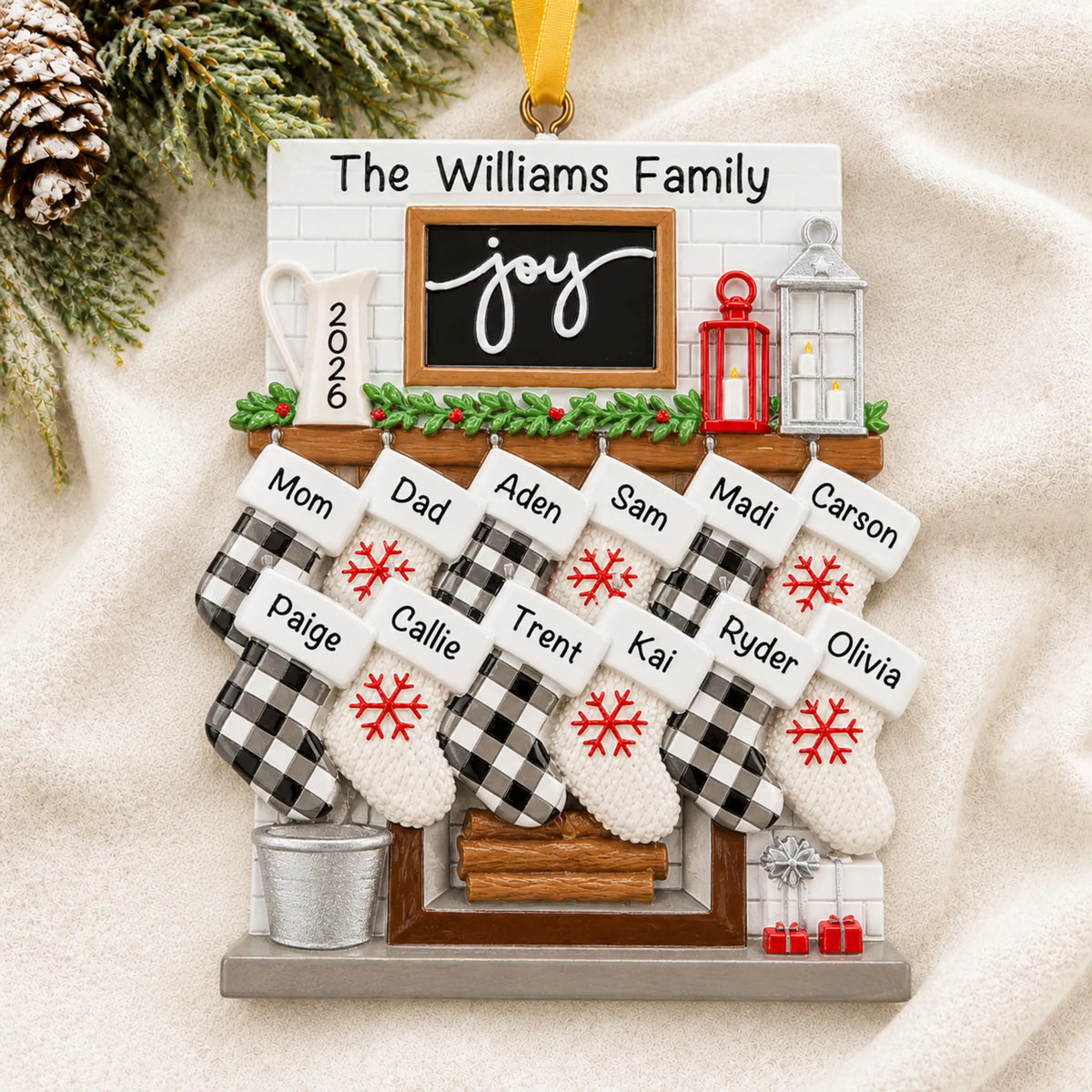 Personalized fireplace stockings family of 12 christmas ornament laid on a soft white knit blanket