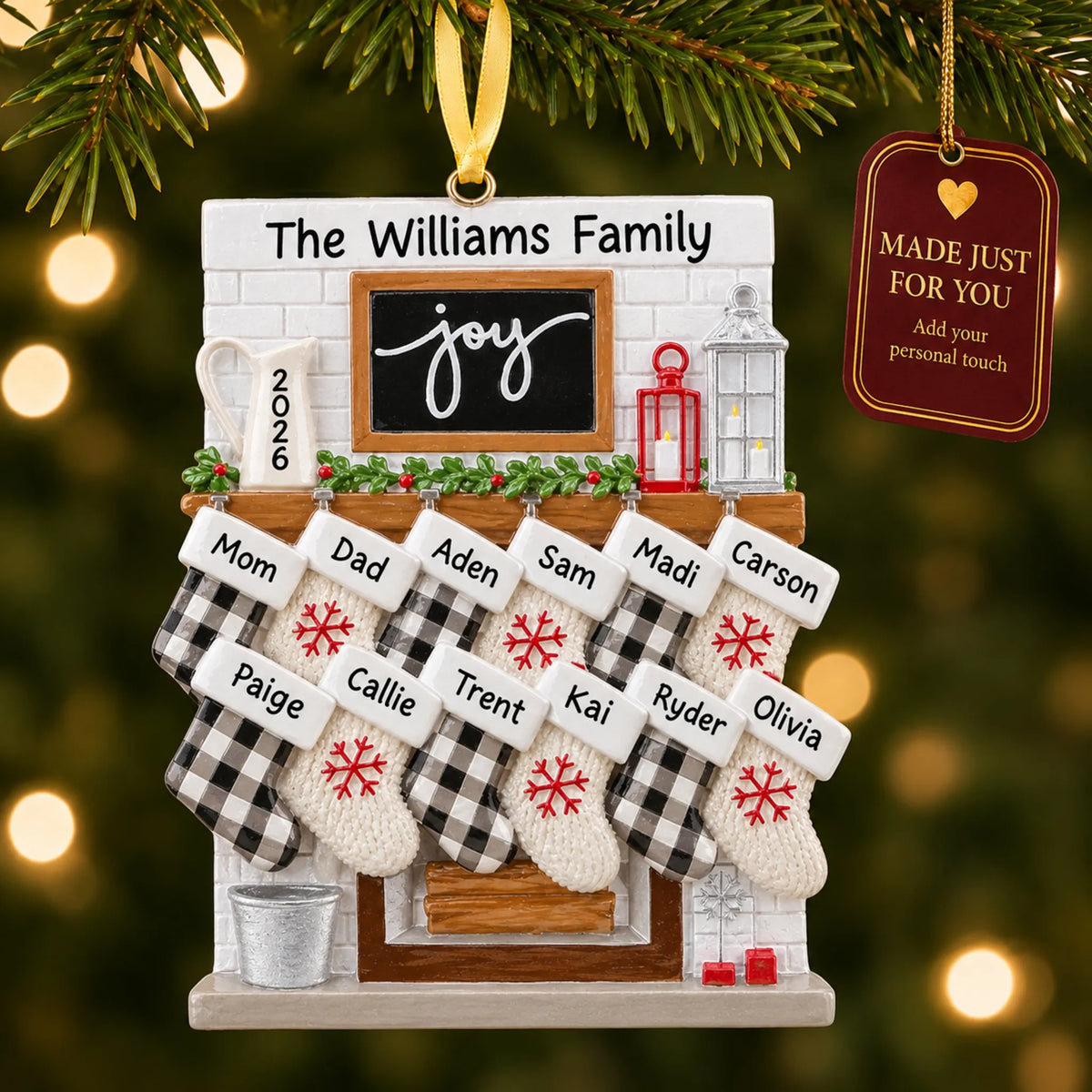 Fireplace stockings family of 12 christmas ornament hanging on a lit Christmas tree with a Made Just For You gift tag