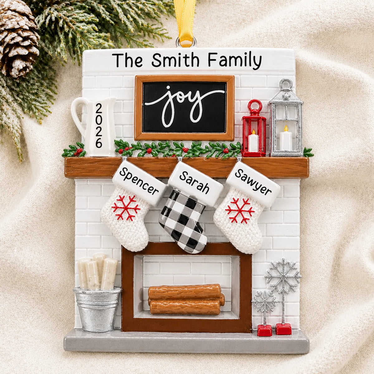 Personalized fireplace stockings family of 3 christmas ornament laid on a soft white knit blanket