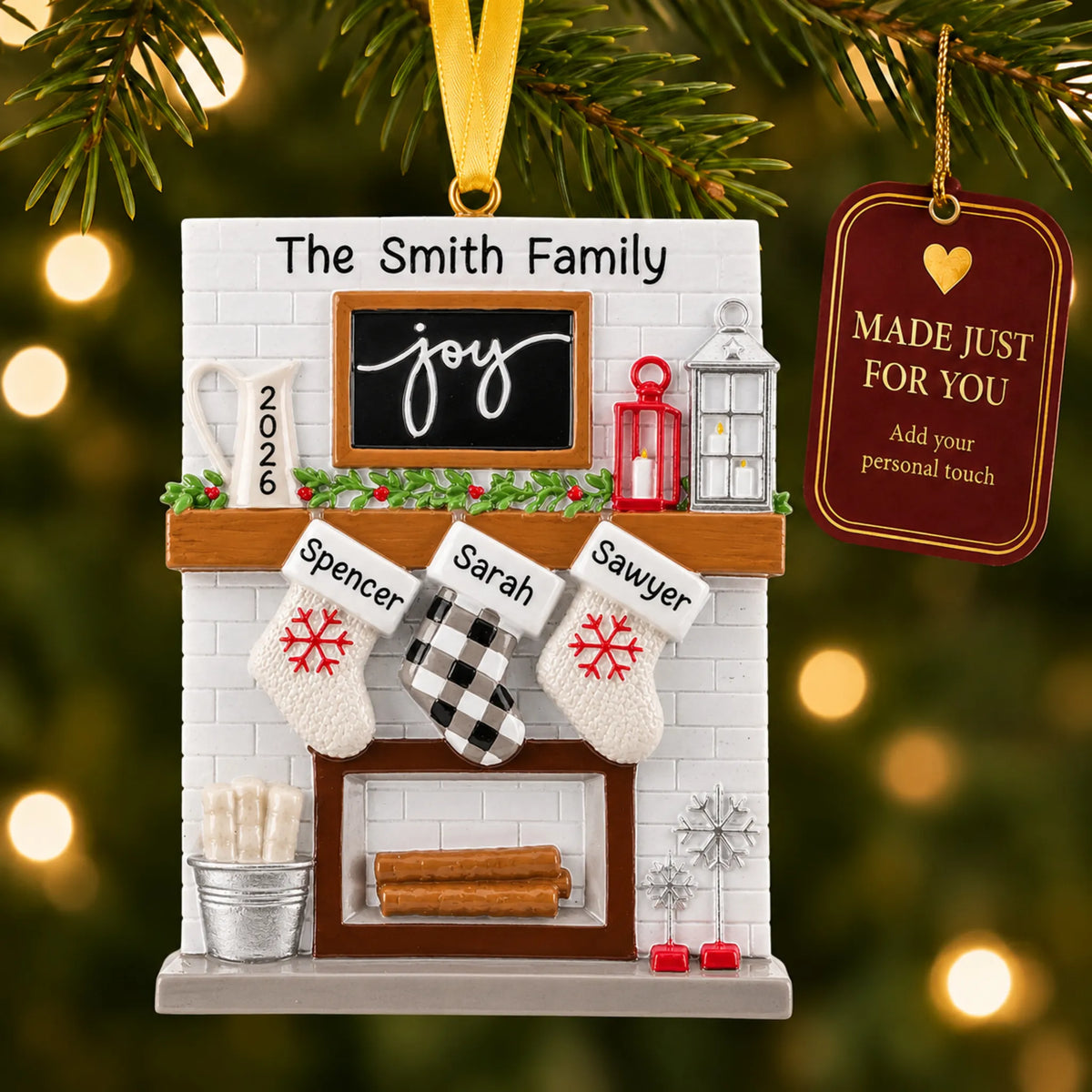 Fireplace stockings family of 3 christmas ornament hanging on a lit Christmas tree with a Made Just For You gift tag