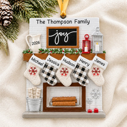 Personalized fireplace stockings family of 5 christmas ornament laid on a soft white knit blanket