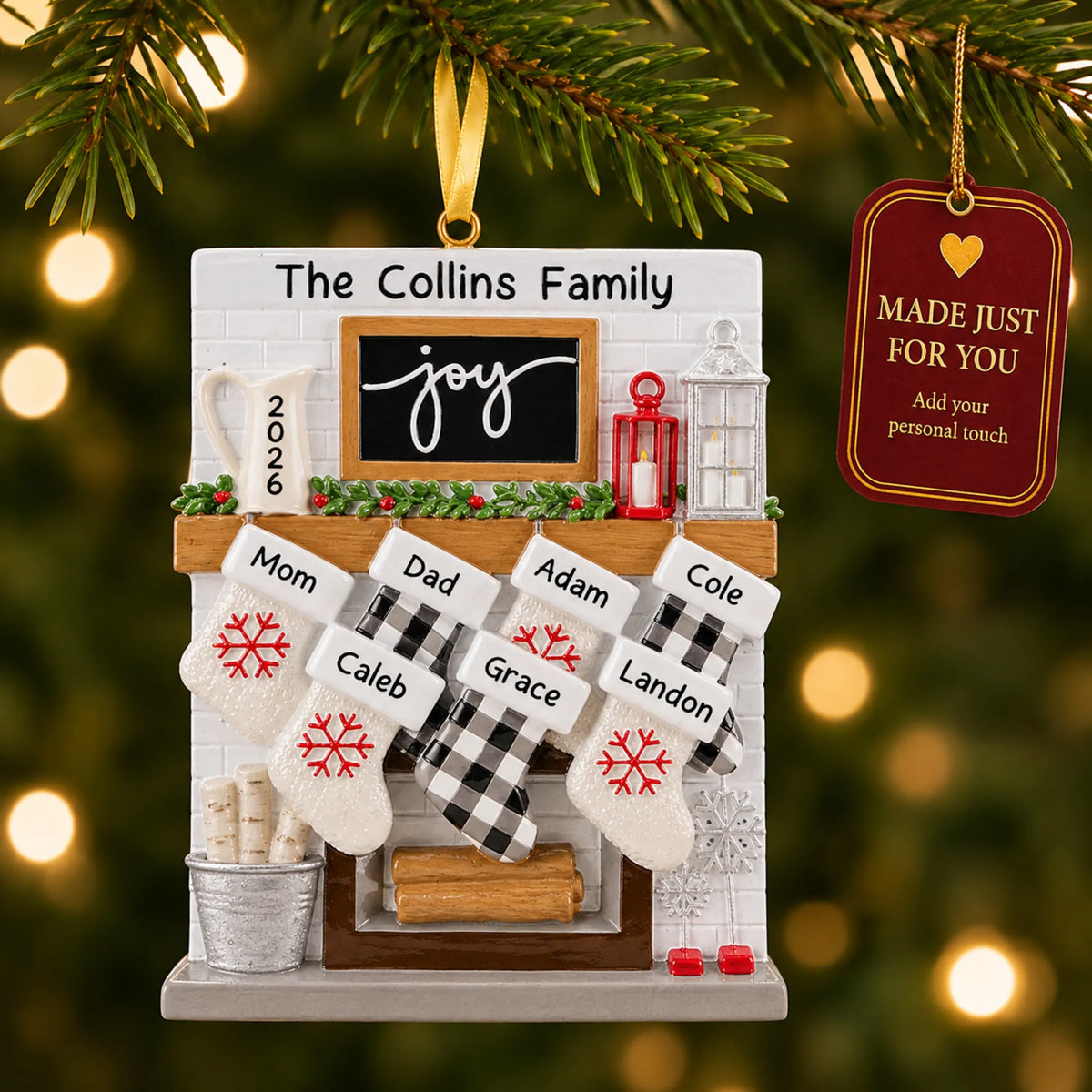 Fireplace stockings family of 7 christmas ornament hanging on a lit Christmas tree with a Made Just For You gift tag