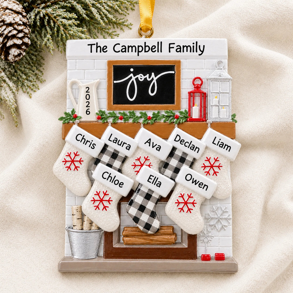 Personalized fireplace stockings family of 8 christmas ornament laid on a soft white knit blanket