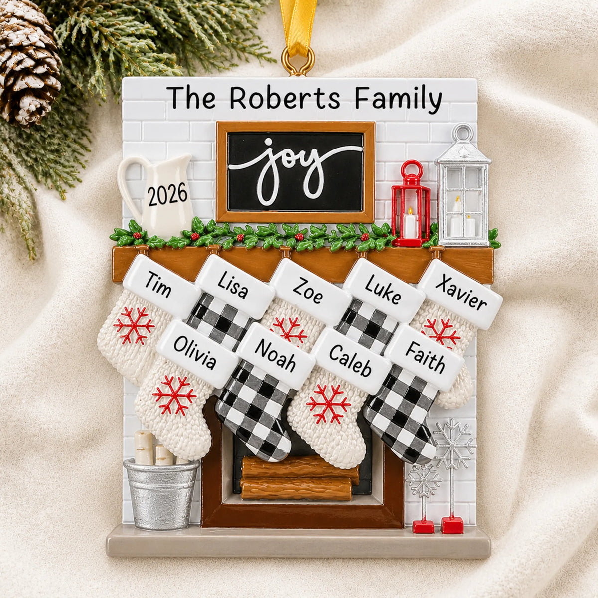 Personalized fireplace stockings family of 9 christmas ornament laid on a soft white knit blanket