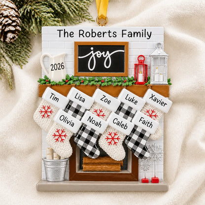 Personalized fireplace stockings family of 9 christmas ornament laid on a soft white knit blanket