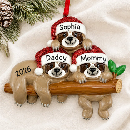 Personalized sloth family of 3 christmas ornament laid on a soft white knit blanket