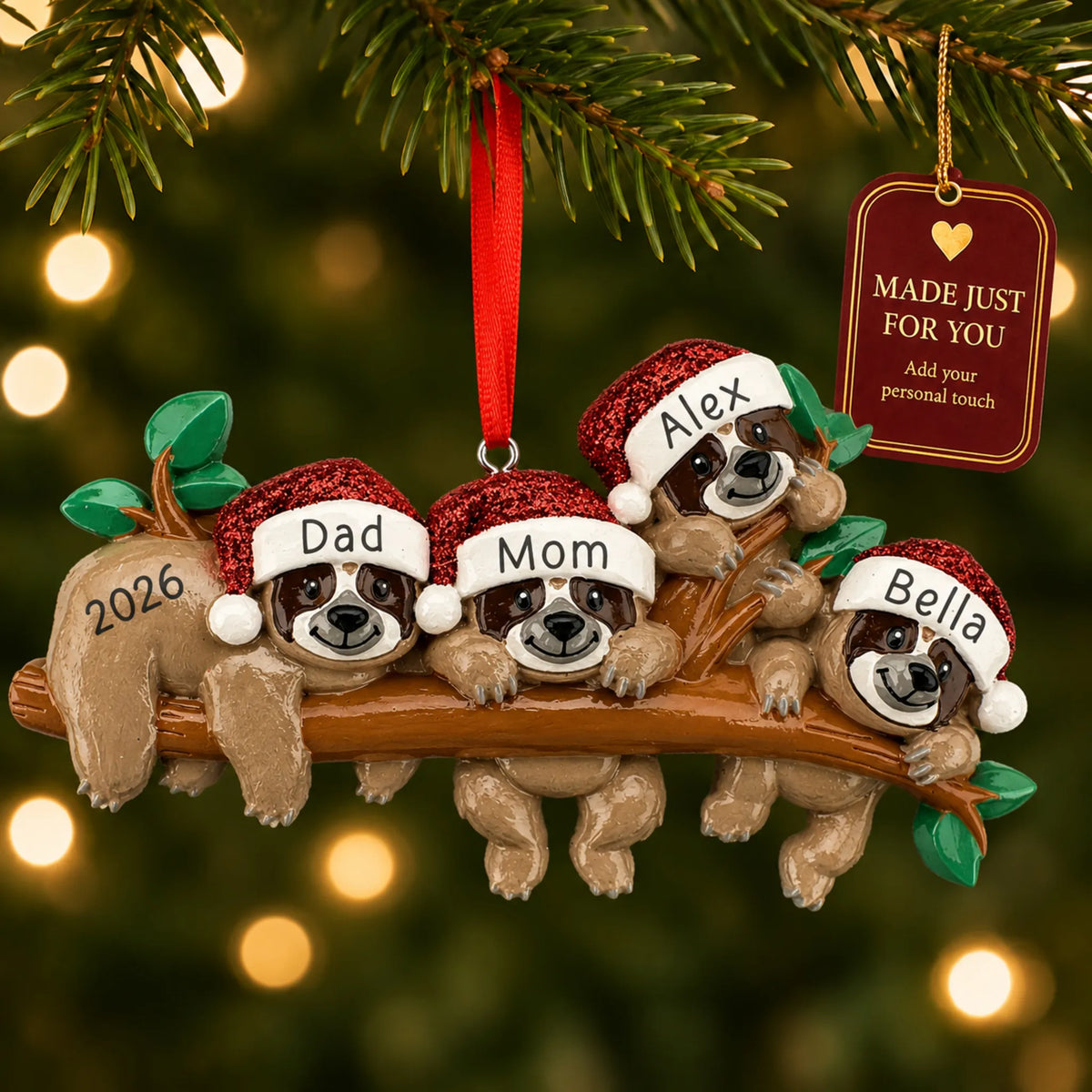 Sloth family of 4 christmas ornament hanging on a lit Christmas tree with a Made Just For You gift tag