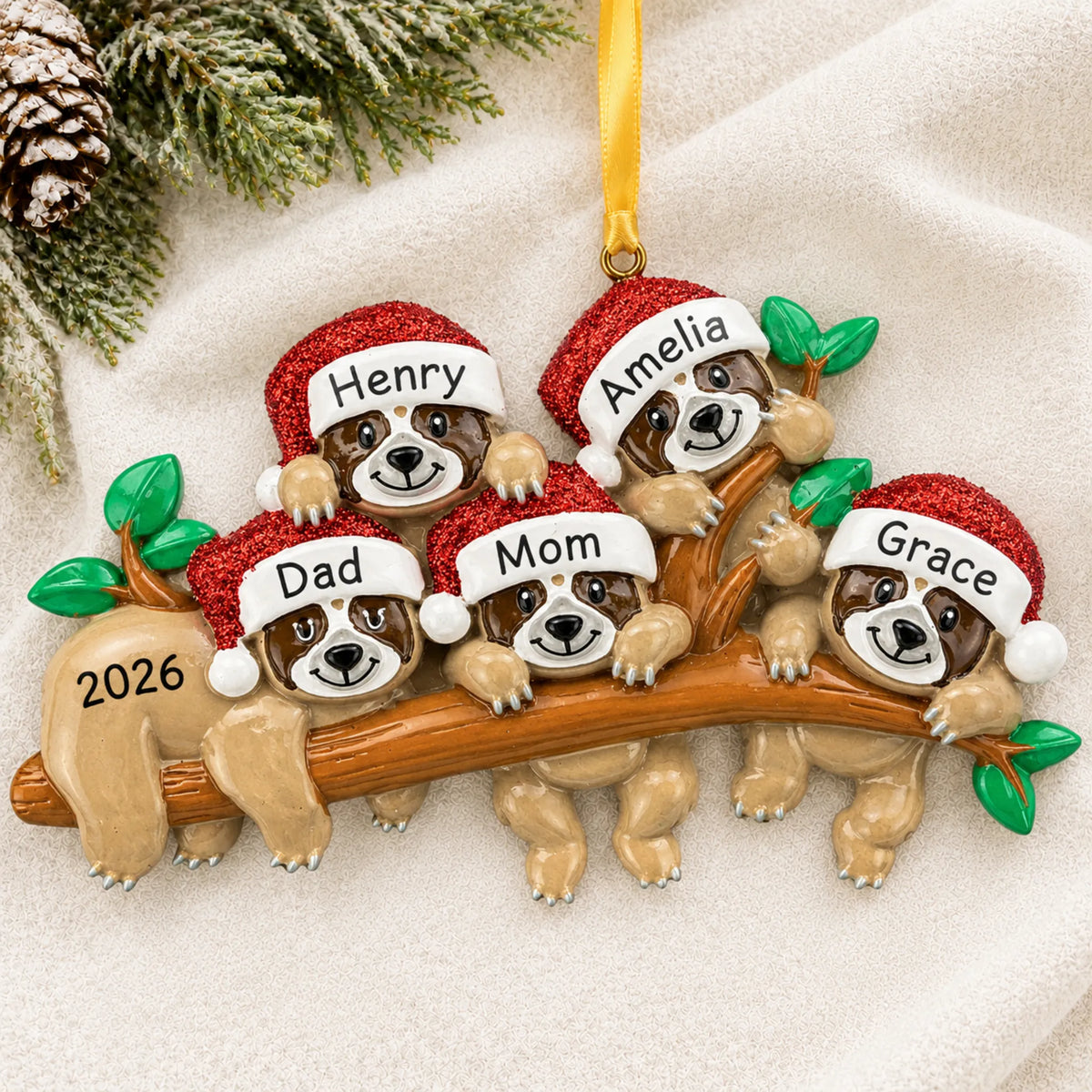 Personalized sloth family of 5 christmas ornament laid on a soft white knit blanket
