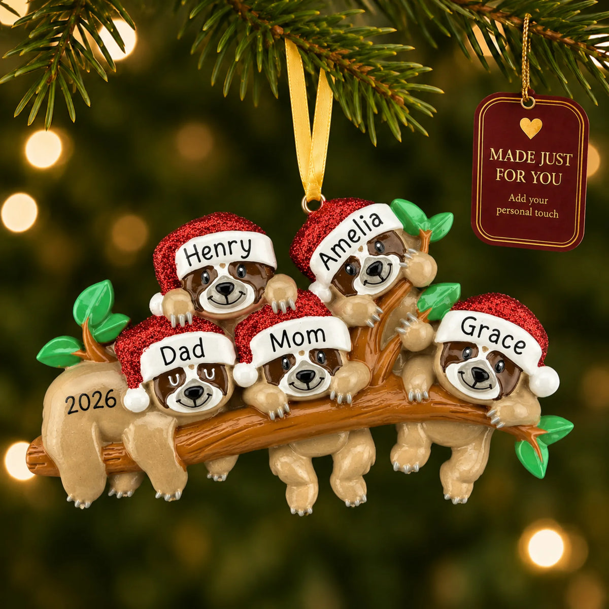 Sloth family of 5 christmas ornament hanging on a lit Christmas tree with a Made Just For You gift tag
