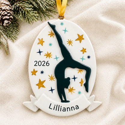 Personalized gymnastics superstar christmas ornament laid on a soft white knit blanket