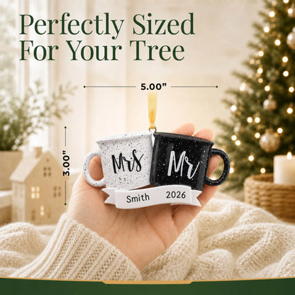 Personalized Mr & Mrs couple mug Christmas ornament held in a hand to show its 5 by 3 inch size