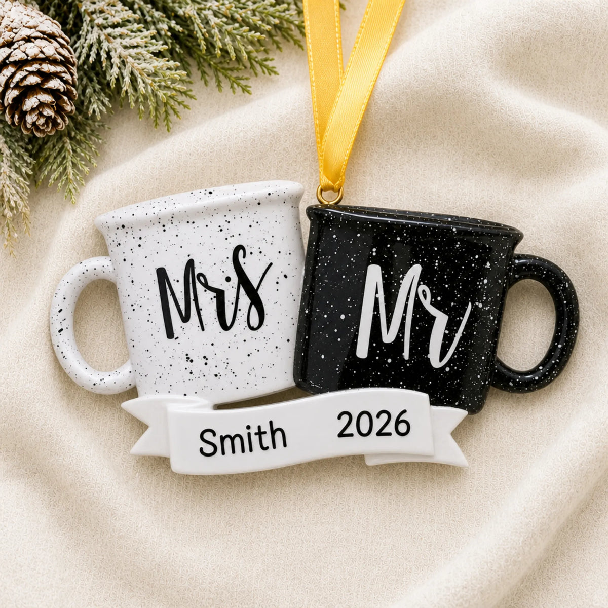 Personalized Mr & Mrs couple mug Christmas ornament on a cream knit blanket beside pine and pinecones