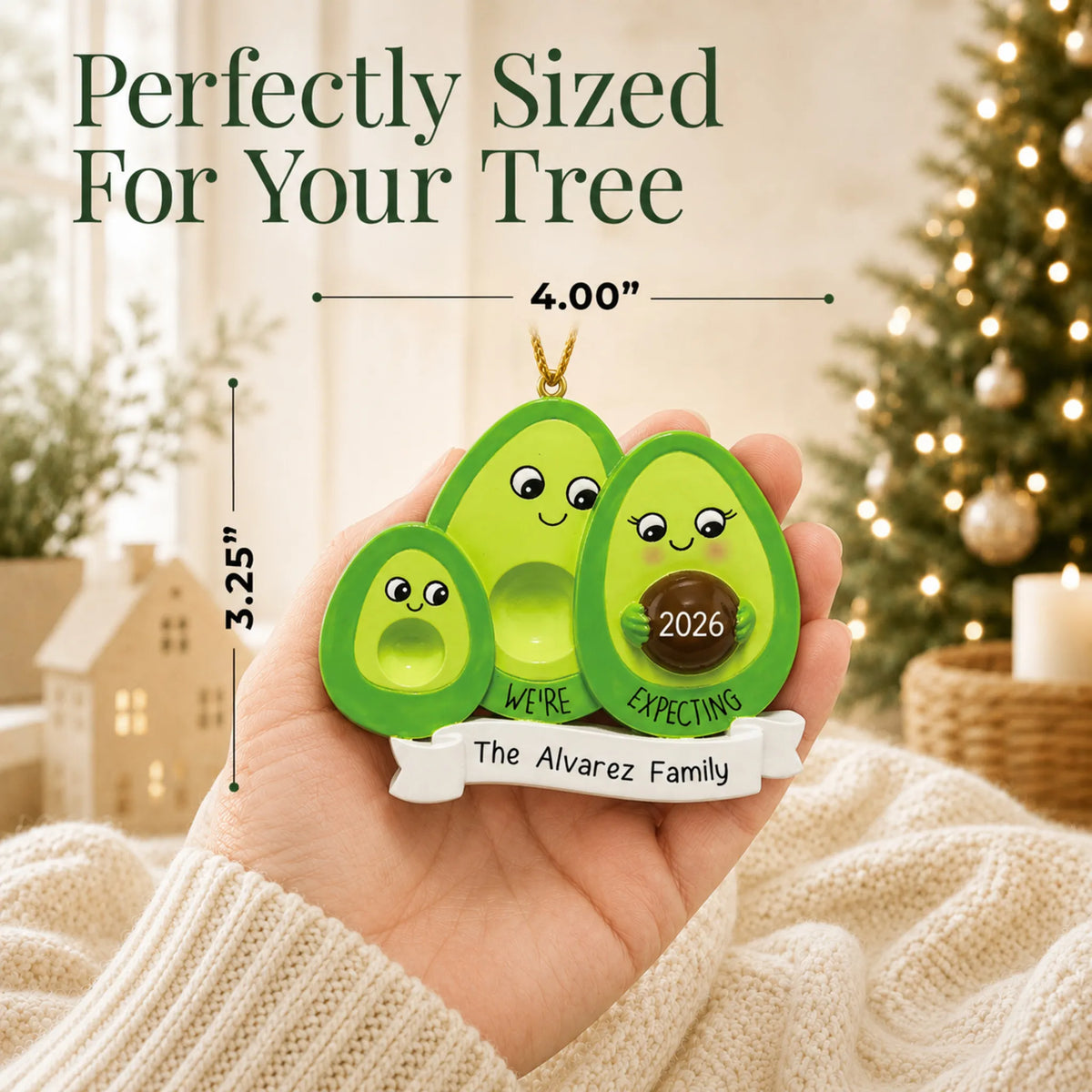 Size guide: the personalized Avocado Expecting Family of 3 christmas ornament is 4.00 in wide by 3.25 in tall, shown in hand