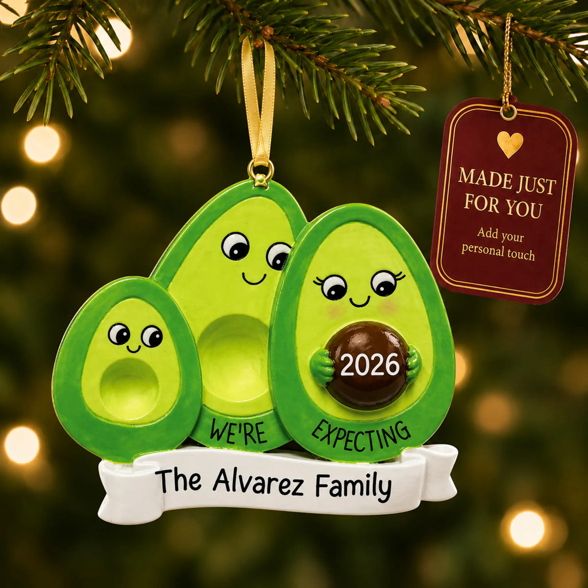 Avocado Expecting Family of 3 christmas ornament hanging on a lit Christmas tree with a Made Just For You gift tag