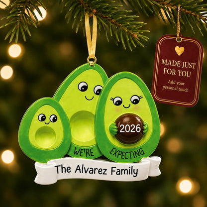 Avocado Expecting Family of 3 christmas ornament hanging on a lit Christmas tree with a Made Just For You gift tag